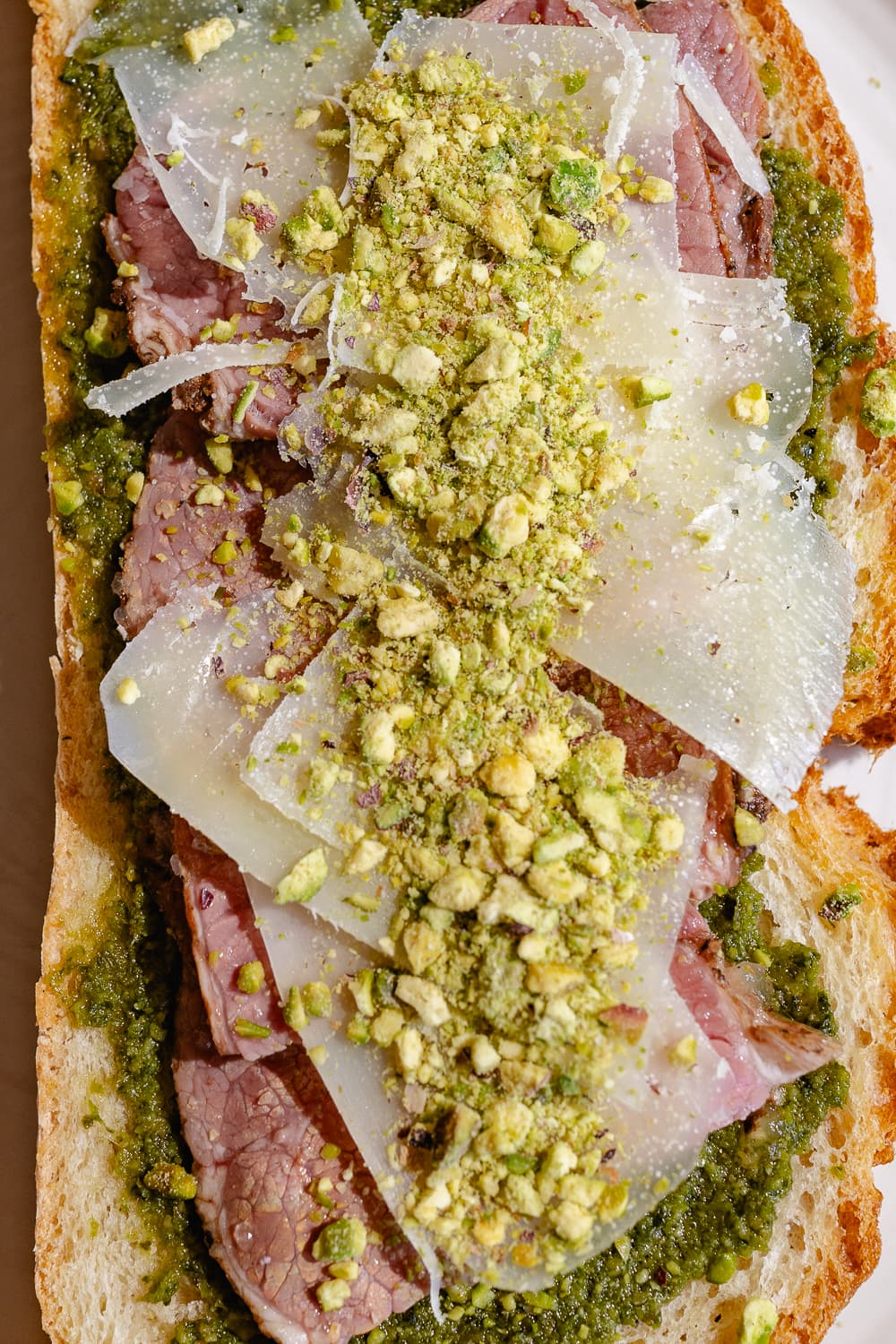 Tostada salada con pesto y queso rallado en Essenza